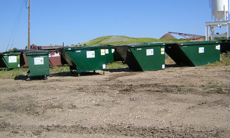 Photo of several commercial trash containers in various sizes.