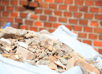 Photo of broken bricks and miscellaneous debris at construction site.